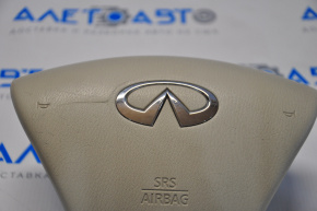 Airbag-ul din volanul șoferului pentru Infiniti JX35 QX60 13- este de culoare bej și este comprimat