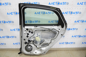 Ușa din spate dreapta asamblată Ford Focus mk3 11-18 argintiu UX, ușor lovită.