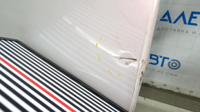 Ușa stângă față a unui Honda CRV 17-22, albă, NH-883P, este îndoită, are lovituri și zgârieturi.
